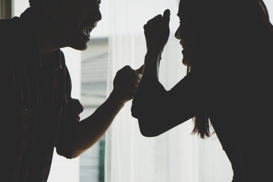 Silhouette Asian couple is fighting by the windows