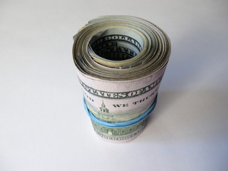 A bundle of dollars on a white background. A roll of hundred dollar bills.