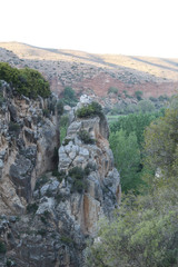 A rural landscape with a canyon dug by the Aguavivas river, at the sunset, with some cultivated...