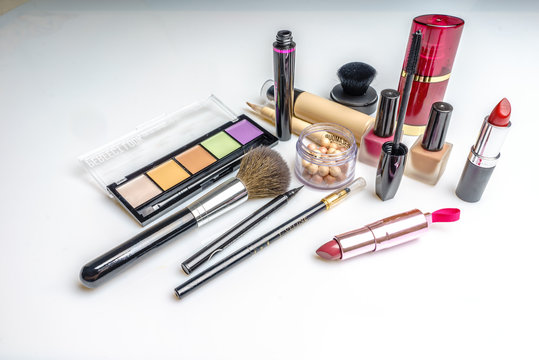 Makeup, cosmetics products on light background. Top view. Decorative cosmetics and accessory with empty space