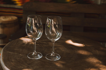 close-up shot of glasses for wine on rustic wooden table