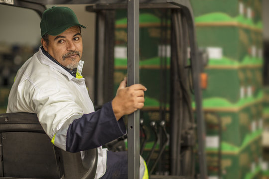 Worker sitting in forklift