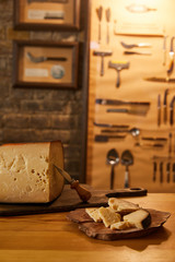 close-up shot of sliced cheese with knife on wooden boards