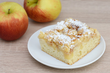 apple cake and apple standing on table