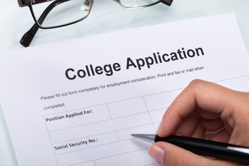 Person Filling College Application Form