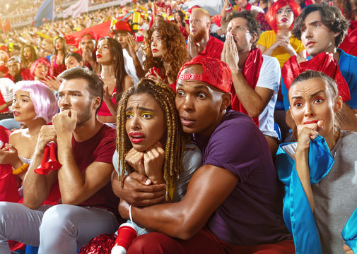 Young Sport Supporter Fans At Stadium. Tense Moment In The Game. Fans In Anticipation During The Match