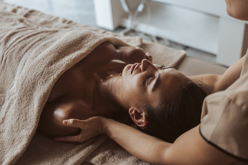 Fototapeta na wymiar Woman enjoying massage in Spa