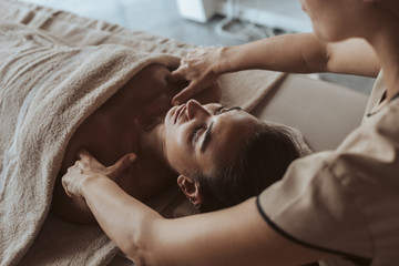 Fototapeta na wymiar Woman enjoying massage in Spa