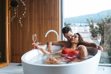 Couple enjoying a bath with champagne