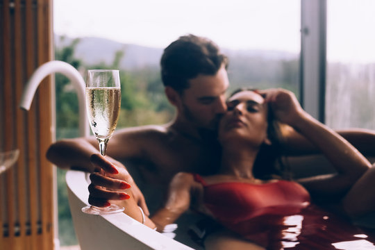 Couple enjoying a bath with champagne