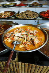 crab curry and assortment of asian dishes 