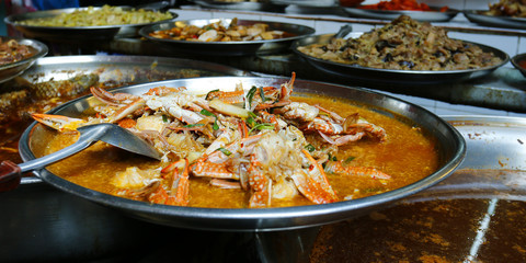 crab curry and assortment of asian dishes 
