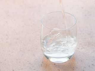 sparkling mineral water pours in glass