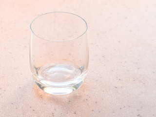 empty glass on pink board