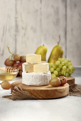 Brie cheese and camembert with honey grapes and pears