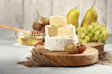 Brie cheese and camembert with honey grapes and pears