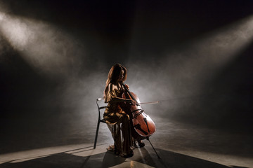 The cellist performs on stage.