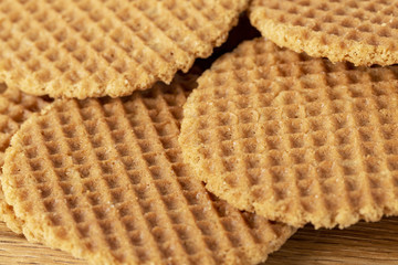 Waffles scattered on a wooden table. Macro. Copy space.