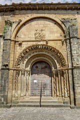 Fototapeta na wymiar The brick made Romanesque entrance of the Holy Mary Church (Iglesia de Santa Maria) in Uncastillo, a small rural town in the Aragon region, in Spain