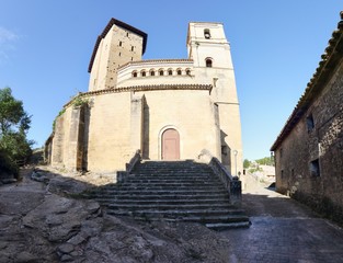 Fototapeta na wymiar A wide angle panorama of the reinforced Saint Martin Church (Iglesia de San Martin) which served also as a fortress in the small rural town of Biel, in Aragon, Spain