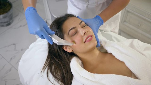 Skin care face, client female on cosmetic rejuvenating procedures with active component delivery technology in Beauty parlor close-up