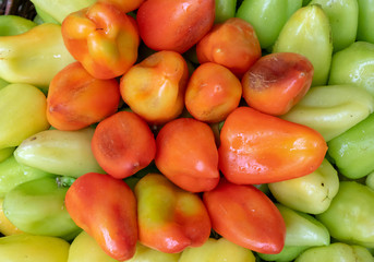 Bulgarian pepper is green and red in the basket.