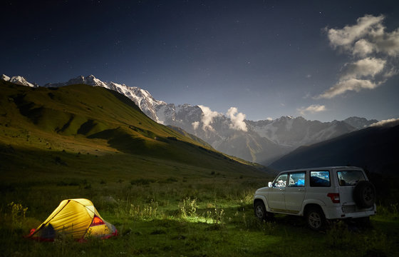 camping with a car at moon night.