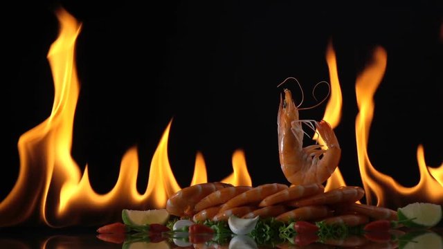 grill shrimp , barbecue sea food on fire flaming slow motion background.