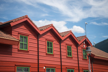low angle view of red wooden houses in Flam village, Aurlandsfjord (Aurlandsfjorden), Norway
