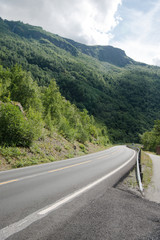 empty asphalt road and beautiful mountains covered with green vegetation, Aurlandsfjord, Flam (Aurlandsfjorden), Norway