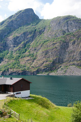 Fototapeta na wymiar cozy wooden house on coast of beautiful Aurlandsfjord, Flam (Aurlandsfjorden), Norway