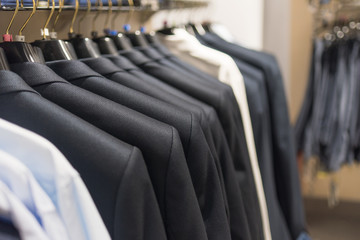 Men's jackets on hangers in a men's clothing store