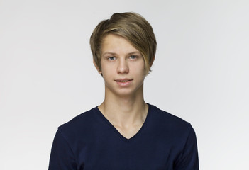Handsome happy young man wearing blue t-shirt studio portrait against white wall