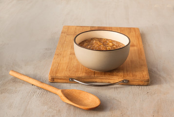 Chutney of apples, onions, pepper and cinnamon in a gray ceramic bowl.