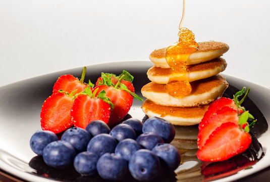Healthy pancakes with strawberries and blueberries breakfast