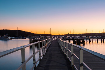 Fototapeta na wymiar Perspective view of Balmoral Beach pier at dawn. Sydney, Australia.