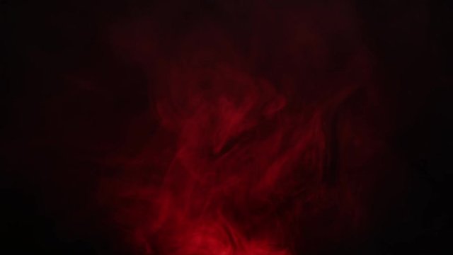 Red smoke on dark background. Smoke curling over a luminous flashlight. Divination over the magical vessel. Beautiful red smoke intro for logo.