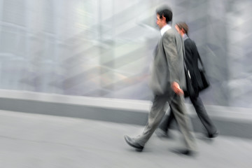 motion blurred business people walking on the street