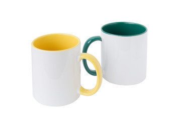 Two white mugs, with a green and yellow handle on a white background.  Isolated.  