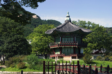 Fototapeta premium The Pavilion of Far-Reaching Fragrance is a small pagoda on an artificial island in the center of a small lake in the Gyeongbokgung Palace complex in Seoul.