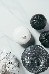top view of decorative black and white pumpkins with paint splatters for halloween party