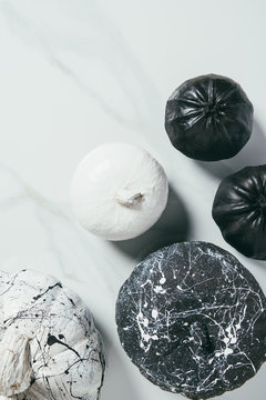 Top View Of Decorative Black And White Pumpkins With Paint Splatters For Halloween Party