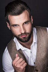 portrait of stylish handsome confident man, isolated on grey