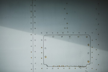 White fuselage of airplane with rivets background.