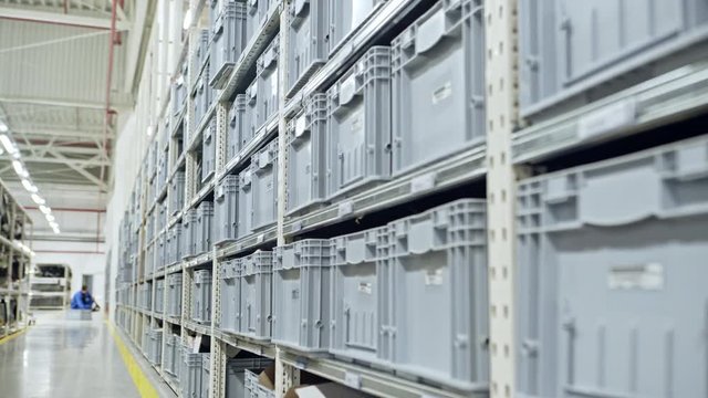 White plastic containers in spacious storehouse