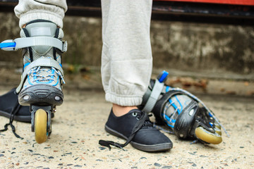 Woman putting on roller skates outdoor.