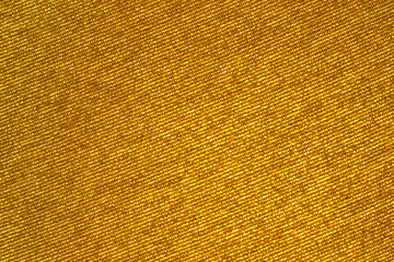 Golden shiny fabric. Abstract sparkling festive background or texture