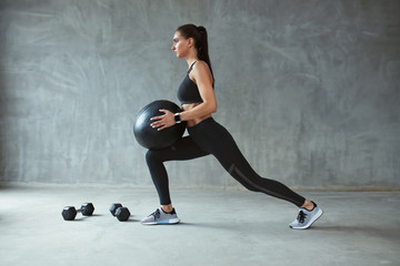 Woman In Stylish Sports Wear Training With Med Ball