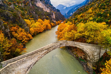 Aerial view of Konitsa old bridge and Aoos River an autumn day, Greece.