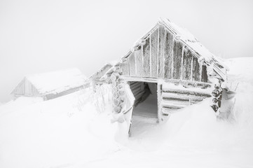 abandoned cabins in the fog after snow storm